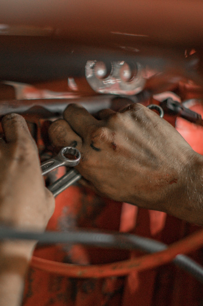 person holding red metal frame
